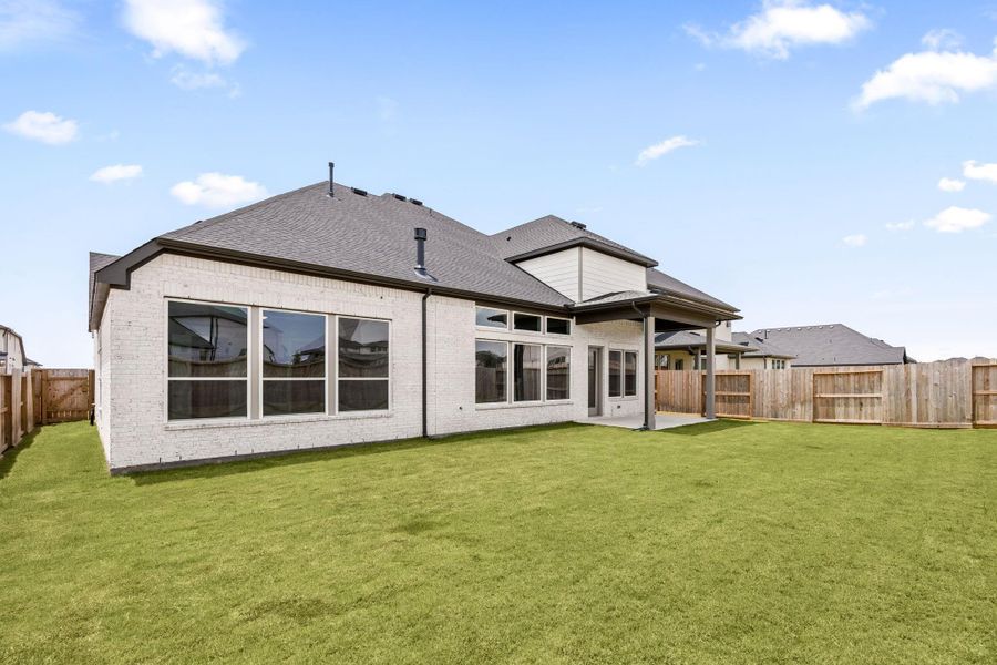 A spacious backyard offers a covered patio and plenty of room to relax or entertain, fully enclosed with a wood privacy fence. A spacious backyard offers a covered patio and plenty of room to relax or entertain, fully enclosed with a wood privacy fence.