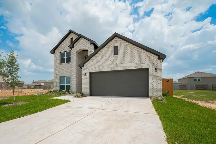 Front exterior of a new home in Sunterra, Katy, TX, highlighting curb appeal (Image 2).