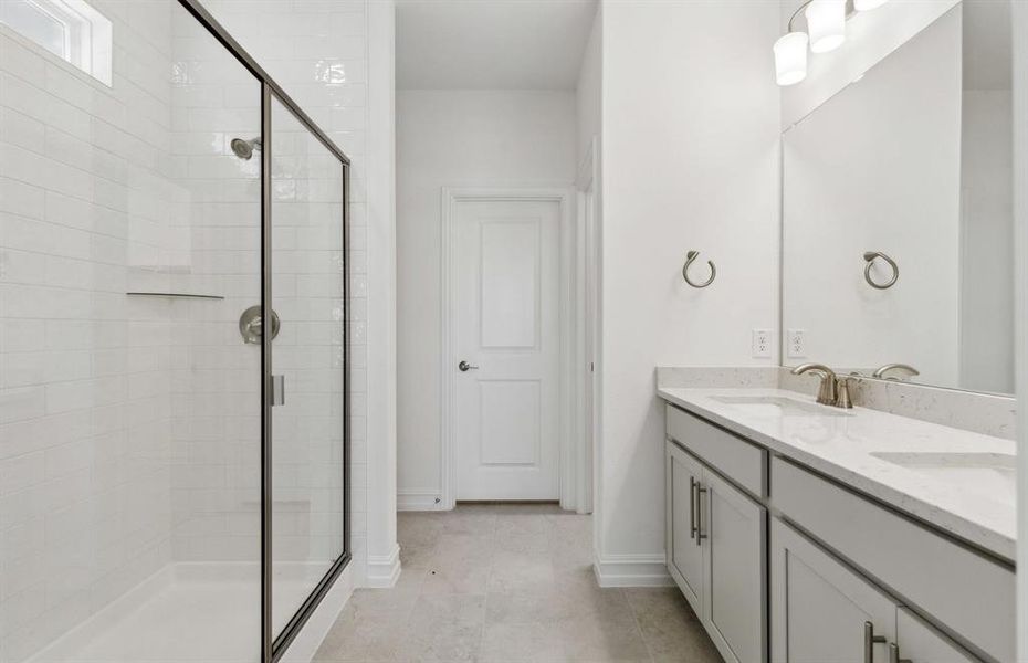 Owner's bath with double vanity and spacious shower Owner's bath with double vanity and spacious shower