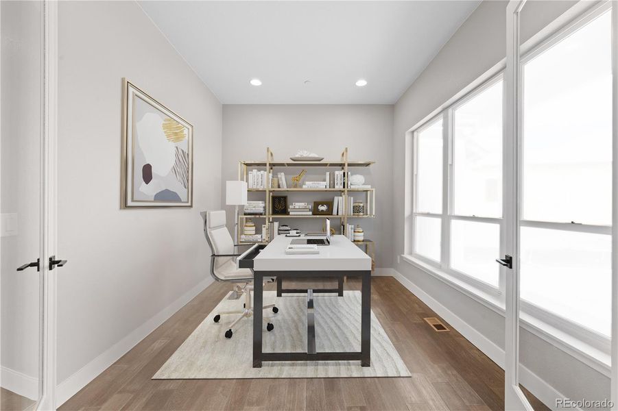 Useful main level office with double glass doors and a window wall overlooking the front yard. *This photo has been virtually staged.