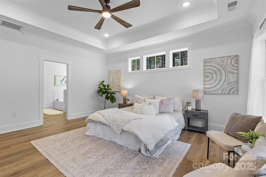 *representative photo- primary bedroom w/ tray ceiling, additional windows for natural light, ensuite bathroom, and a private access to the covered back porch!