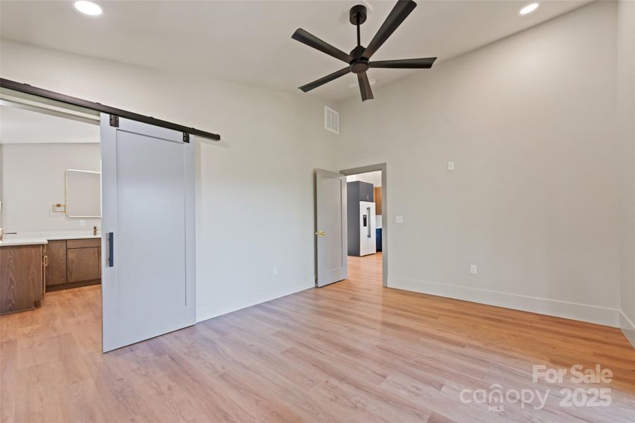 Space saving and stylish barn door in primary suite