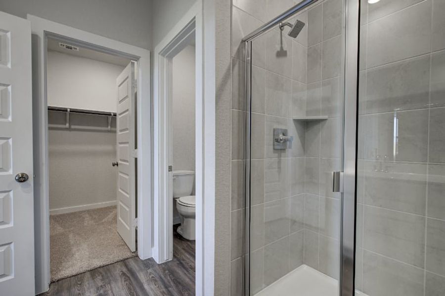A bathroom with a glass shower. A bathroom with a glass shower.