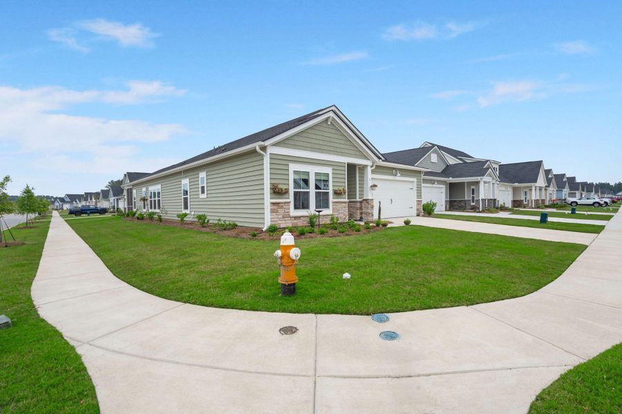 Front exterior of a new home in Horizons at Summers Corner | 55+: The Legends, Summerville, SC, highlighting curb appeal (Image 20).