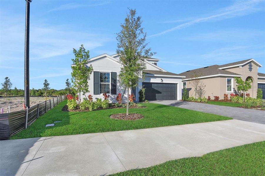 Front exterior of a new home in Turnleaf, Punta Gorda, FL, highlighting curb appeal (Image 26).