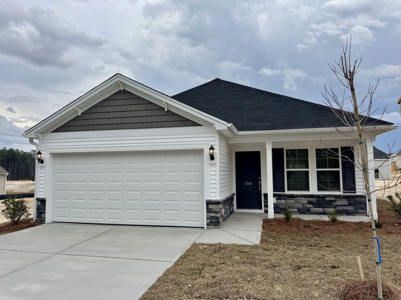 Front exterior of a new home in Ellington, Elgin, SC, highlighting curb appeal (Image 1). Front exterior of a new home in Ellington, Elgin, SC, highlighting curb appeal (Image 1).