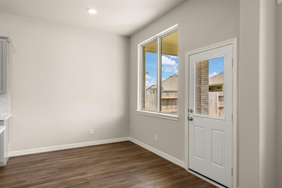 With an abundance of natural light streaming through the windows, the breakfast nook is bathed in a sunny glow, creating the perfect atmosphere to enjoy your morning coffee or a family breakfast.