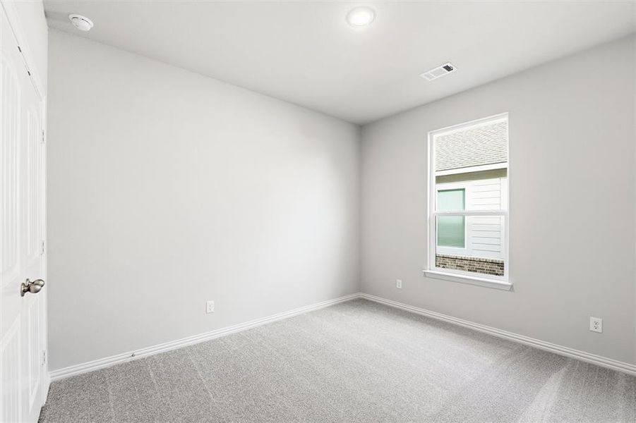 Carpeted spare room with baseboards