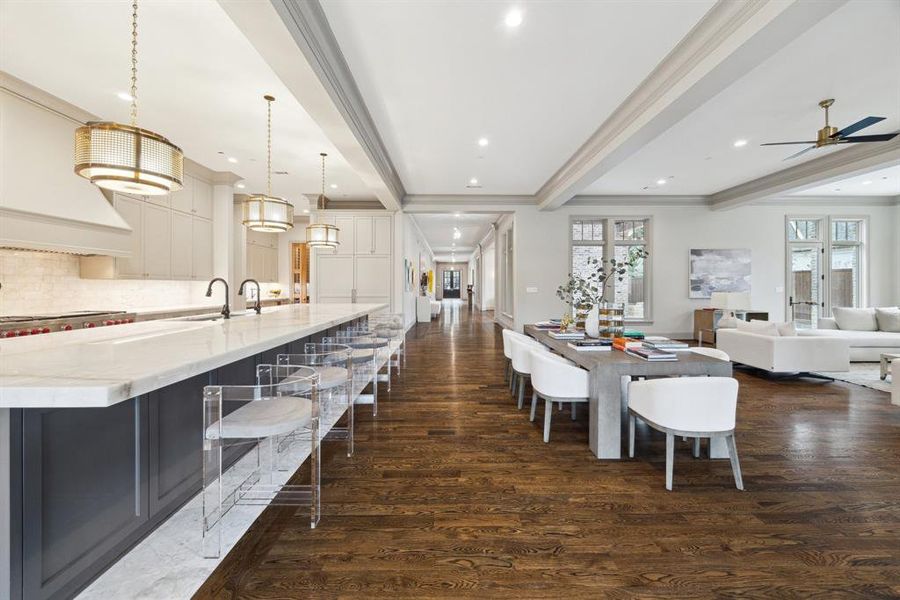 Just Wow! This incredible hallway leads you to the heart of the home, where living and entertaining come together seamlessly. Notice every detail, from the rich floors to the antique-inspired lighting and the flawless craftsmanship that elevates the space.