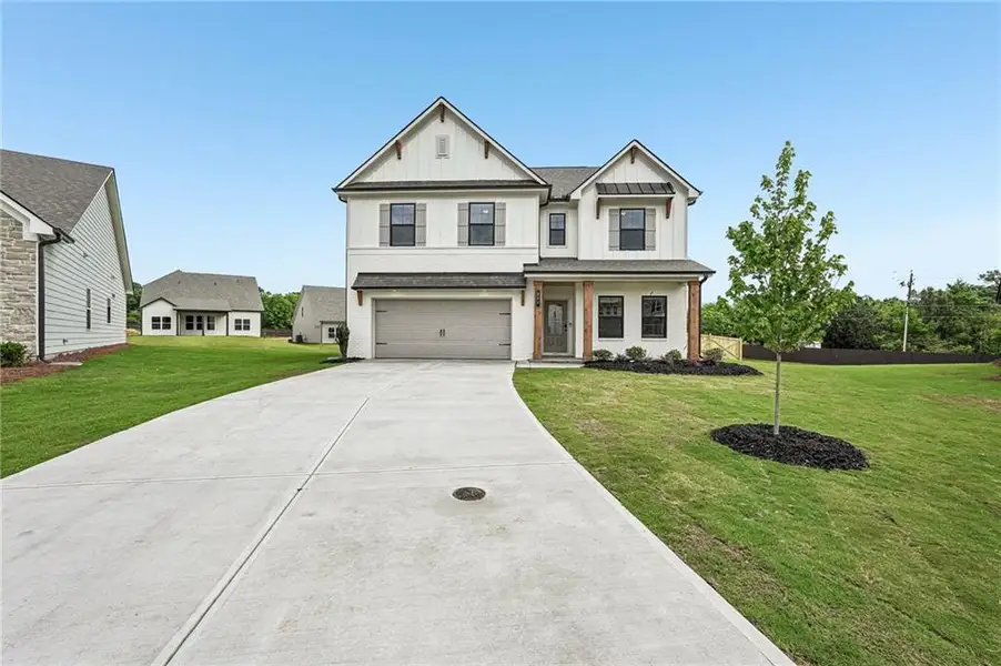 Front exterior of a new home in Pinecrest Ridge, Dacula, GA, highlighting curb appeal (Image 1). Front exterior of a new home in Pinecrest Ridge, Dacula, GA, highlighting curb appeal (Image 1).