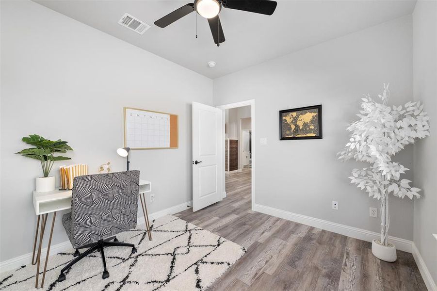 Home office featuring ceiling fan and light wood-type flooring