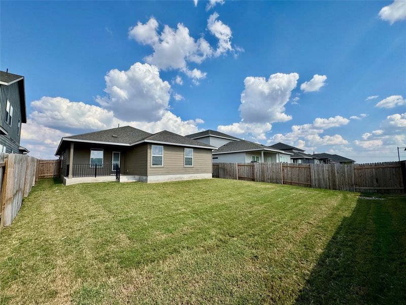 Back of house featuring a patio area, a fenced backyard, and roof with shingles Back of house featuring a patio area, a fenced backyard, and roof with shingles