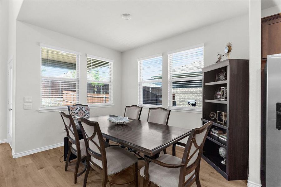 Dining area with baseboards and light wood-style flooring