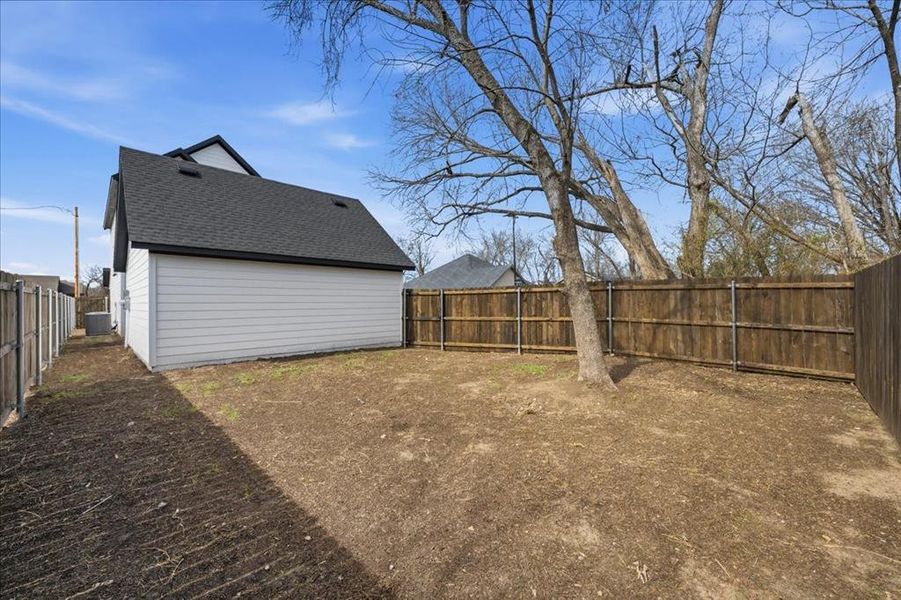 Spacious, fully fenced backyard with mature trees and plenty of room for outdoor living, pets, or play. Detached garage adds additional storage and functionality.