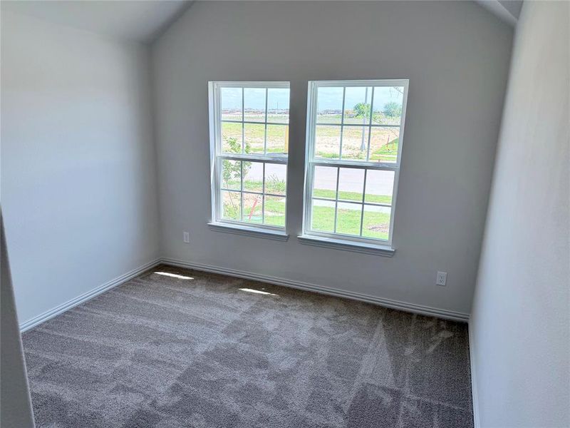 Neutral-toned walls complement the gray patterned carpeting