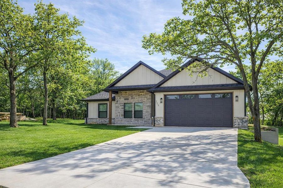 Front exterior of a new home in , Runaway Bay, TX, highlighting curb appeal (Image 29). Front exterior of a new home in , Runaway Bay, TX, highlighting curb appeal (Image 29).