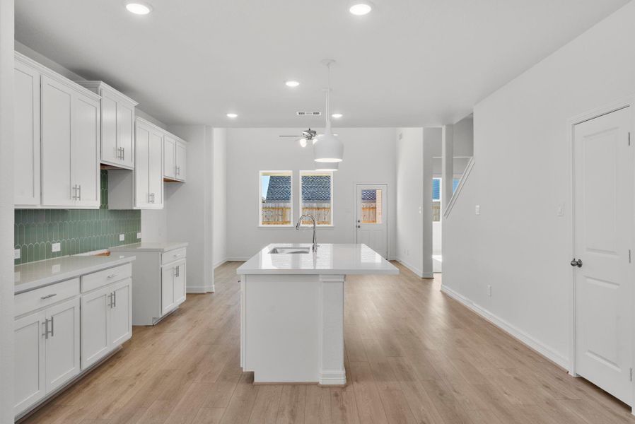 Open-concept kitchen flowing seamlessly into the family room—perfect for entertaining and everyday living.