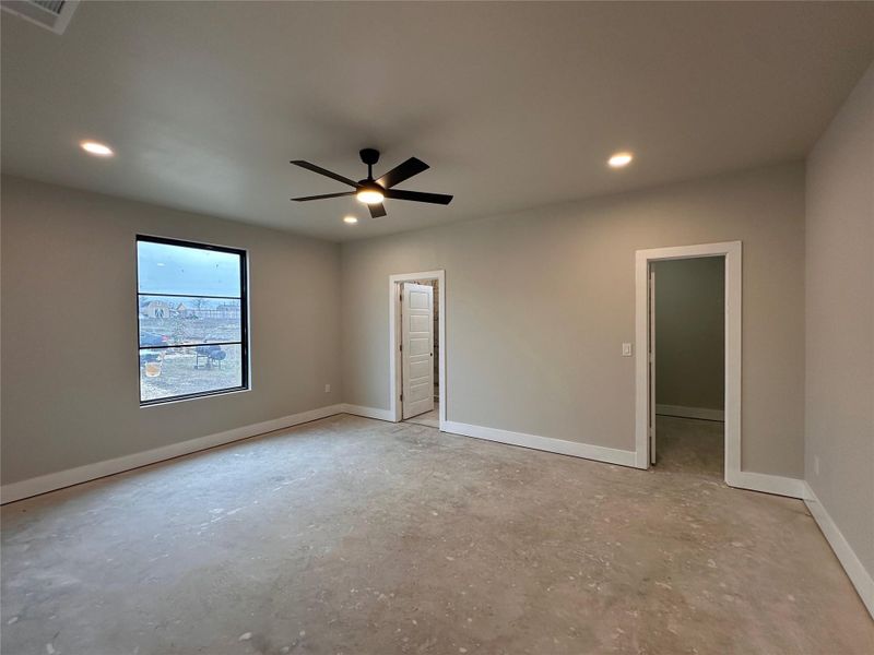 Unfurnished bedroom featuring ceiling fan, a walk in closet, and recessed lighting
