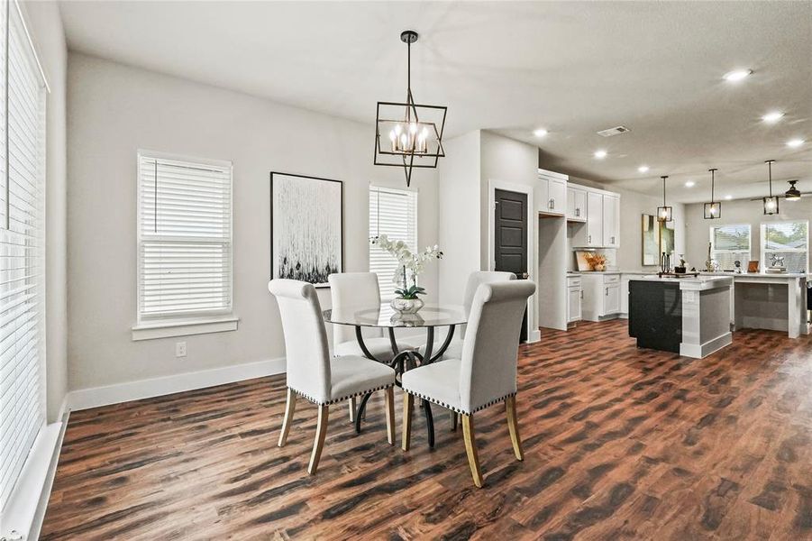 Dining room with recessed lighting, dark wood-style flooring, and a chandelier Dining room with recessed lighting, dark wood-style flooring, and a chandelier