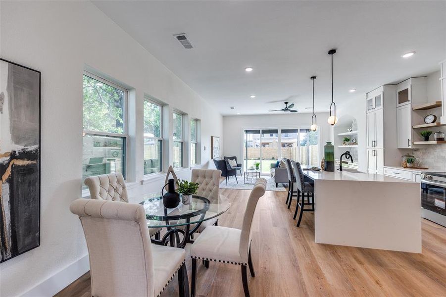 Dining area featuring light wood-style flooring, a ceiling fan, and recessed lighting Dining area featuring light wood-style flooring, a ceiling fan, and recessed lighting