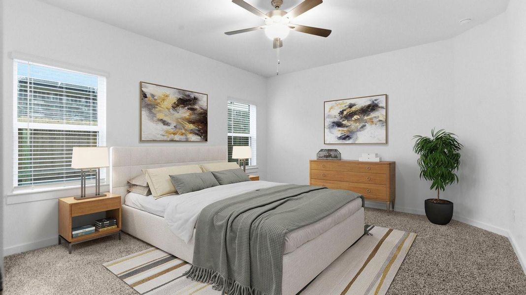 Primary bedroom with ceiling fan, plush carpeting, and a large walk-in closet. Primary bedroom with ceiling fan, plush carpeting, and a large walk-in closet.