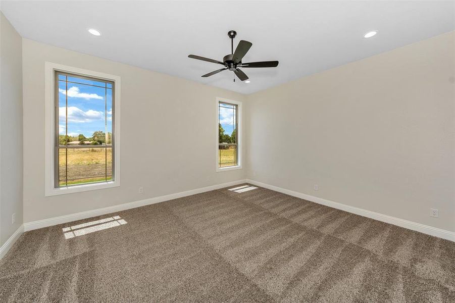 Spare room featuring carpet flooring and ceiling fan