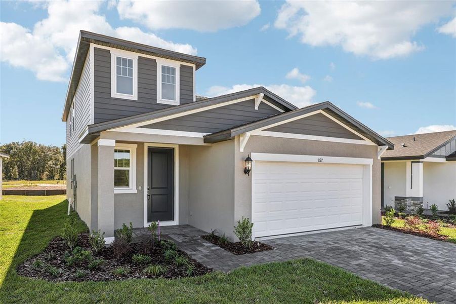 Front exterior of a new home in The Reserve at Hammock Oaks - Classic Series, Lady Lake, FL, highlighting curb appeal (Image 25).