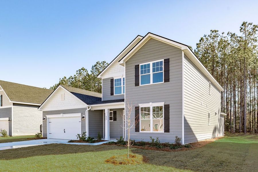 Front exterior of a new home in McAllister Pointe, Richmond Hill, GA, highlighting curb appeal (Image 2). Front exterior of a new home in McAllister Pointe, Richmond Hill, GA, highlighting curb appeal (Image 2).