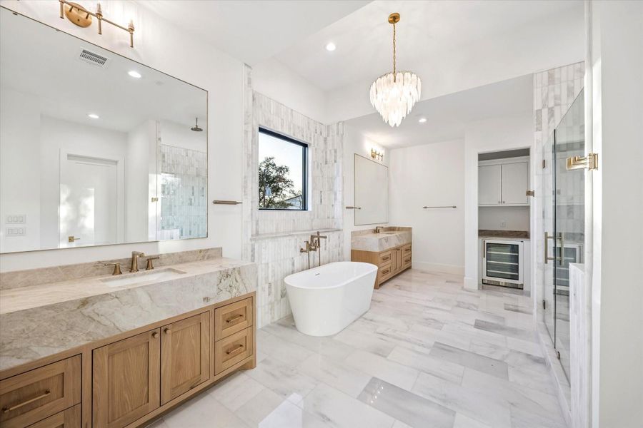 Primary bath feels intentionally spa like with a freestanding soaking tub centered beneath a window and a separate walk in shower for everyday ease. Dual vanities, generous circulation space, and layered lighting elevate both function and comfort.**Previous build by Arch Angelo** Primary bath feels intentionally spa like with a freestanding soaking tub centered beneath a window and a separate walk in shower for everyday ease. Dual vanities, generous circulation space, and layered lighting elevate both function and comfort.**Previous build by Arch Angelo**