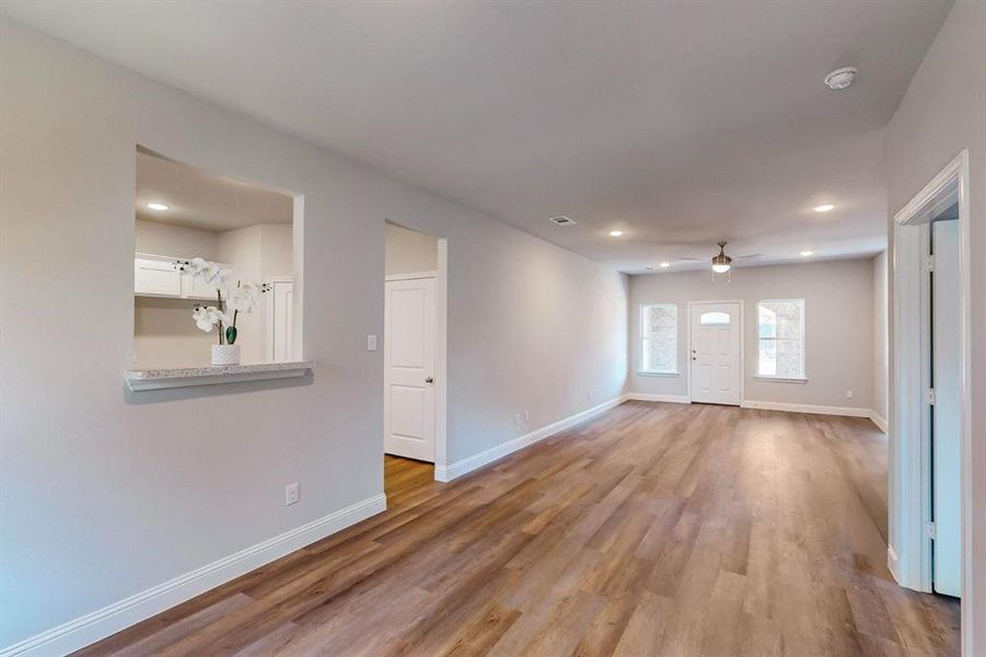 Unfurnished living room featuring light hardwood / wood-style floors and ceiling fan