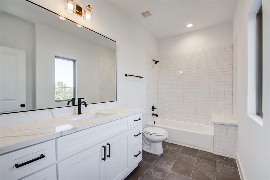 Secondary bath room. Photos of similar completed home by same builder. Selections may differ.