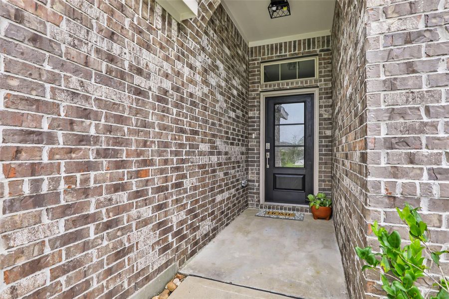 Exterior details and patio area of a home in Pinewood at Grand Texas, New Caney (Image 25).