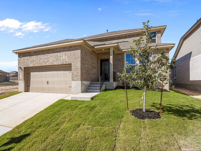 Front exterior of a new home in Comanche Ridge, San Antonio, TX, highlighting curb appeal (Image 26).