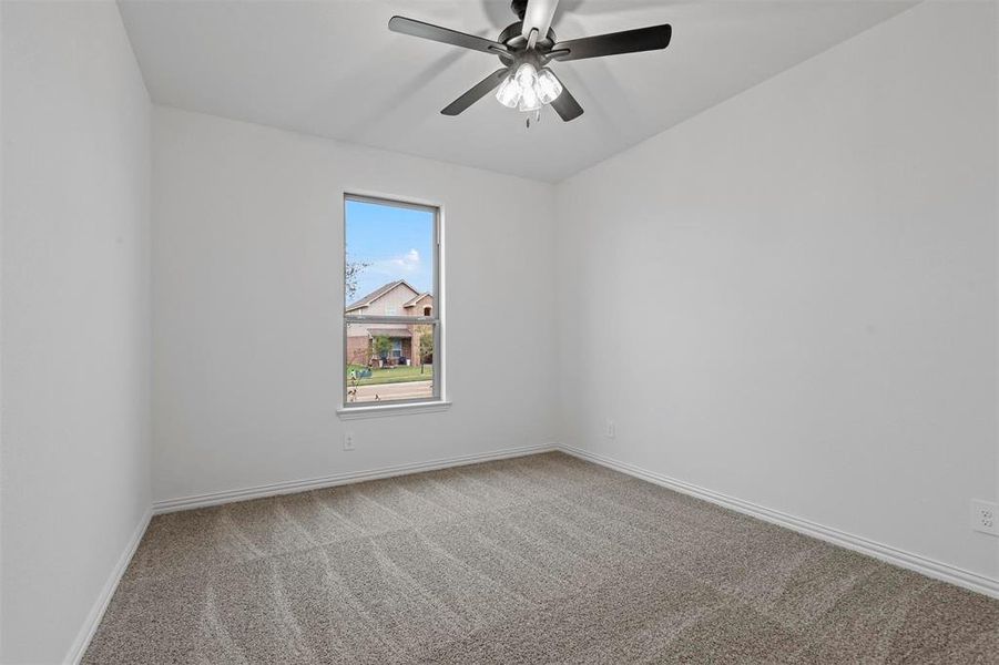 Unfurnished room with ceiling fan and carpet floors