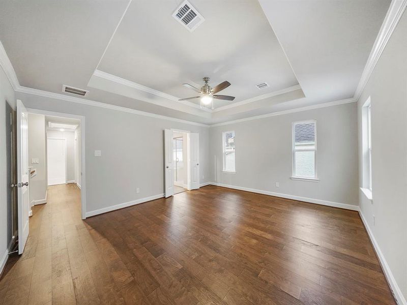 A spacious and well-lit Primary Bedroom with access to a luxurious bathroom and large closet. (Sample photo of a completed Sterling Floor Plan. Image may show alternative features/and or upgrades.)