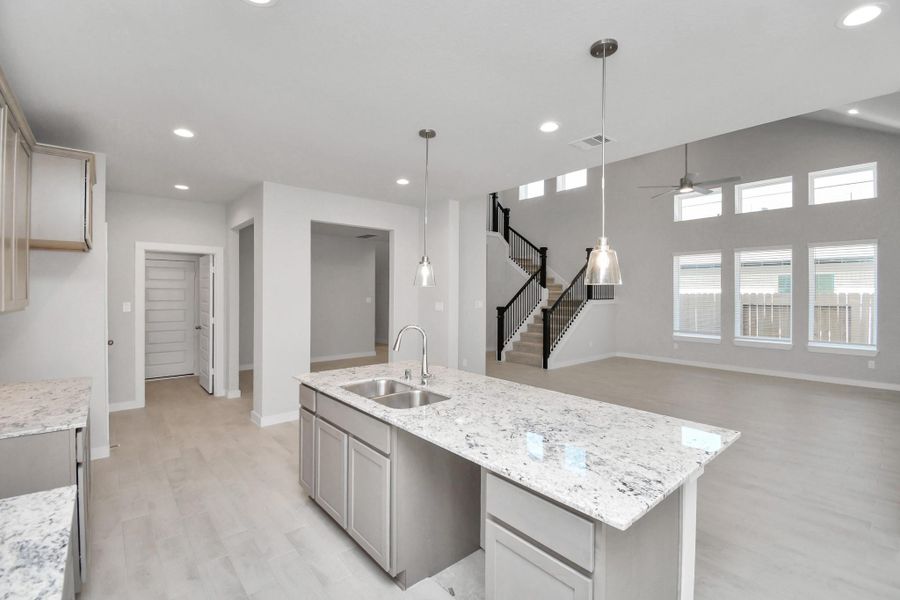 Discover another perspective of this stunning kitchen, generously appointed with an abundance of counter space. Sample photo of completed home with similar floor plan. Actual colors and selections may vary. Discover another perspective of this stunning kitchen, generously appointed with an abundance of counter space. Sample photo of completed home with similar floor plan. Actual colors and selections may vary.