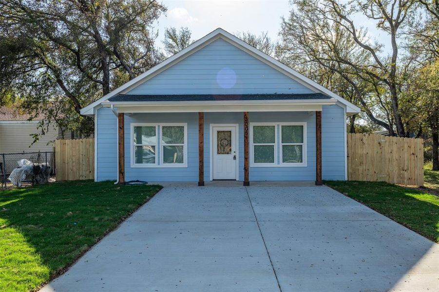 Bungalow-style house with covered porch and a front yard