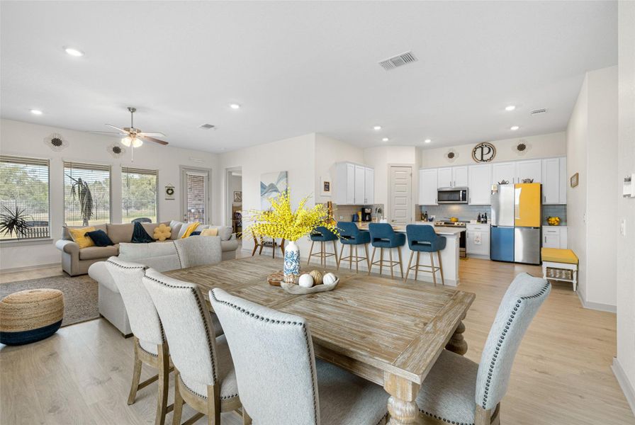 Dining space featuring light wood-type flooring, recessed lighting, and ceiling fan Dining space featuring light wood-type flooring, recessed lighting, and ceiling fan