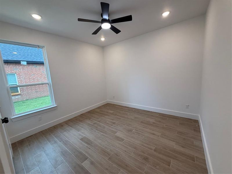 Unfurnished room featuring light wood-style floors, a ceiling fan, and recessed lighting Unfurnished room featuring light wood-style floors, a ceiling fan, and recessed lighting