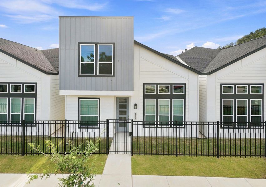 Contemporary two-story design with distinctive architectural lines, contrasting finishes, large windows, and a fenced front yard Contemporary two-story design with distinctive architectural lines, contrasting finishes, large windows, and a fenced front yard