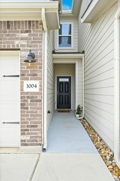 Doorway to property with a garage