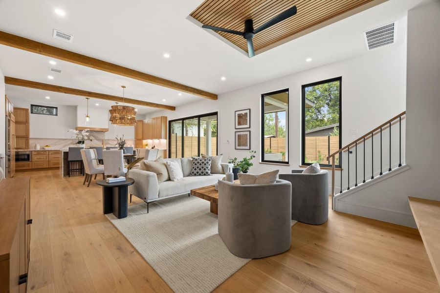Warm wood accents and soaring ceilings define this modern open-concept main floor living space.
