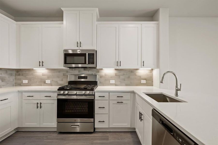 Featuring fantastic storage and prep space, this dream kitchen is finished in a classic color palette that will always be in style!