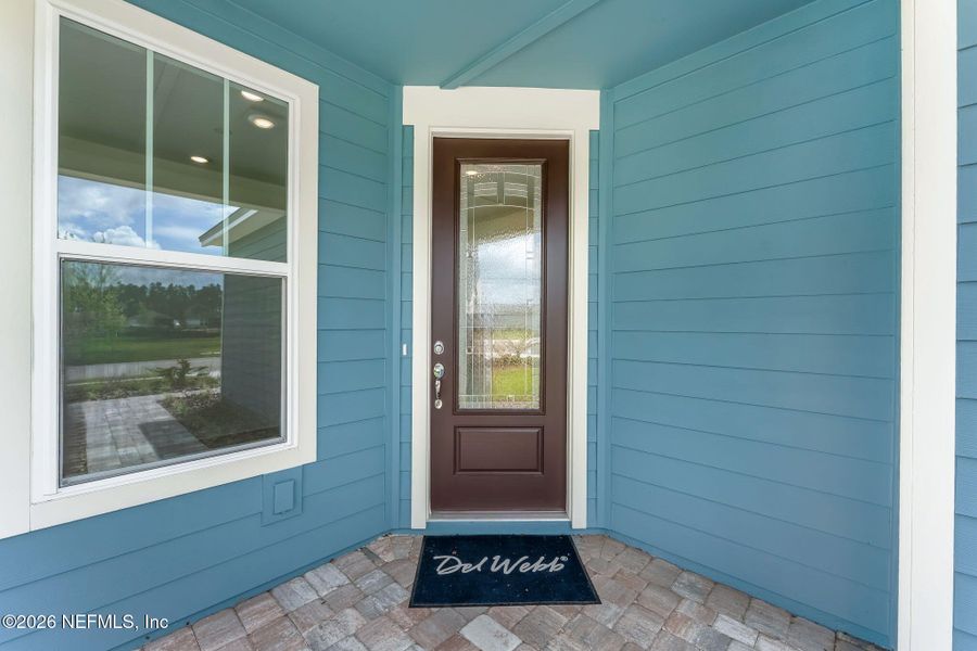 Exterior details and patio area of a home in Del Webb Wildlight, Wildlight (Image 27).