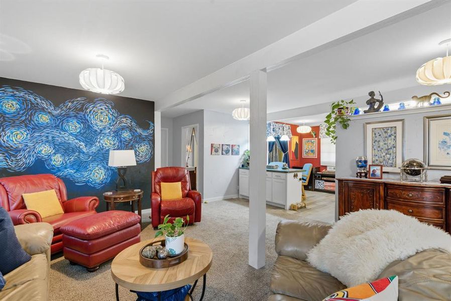 Living room with light colored carpet and baseboards Living room with light colored carpet and baseboards
