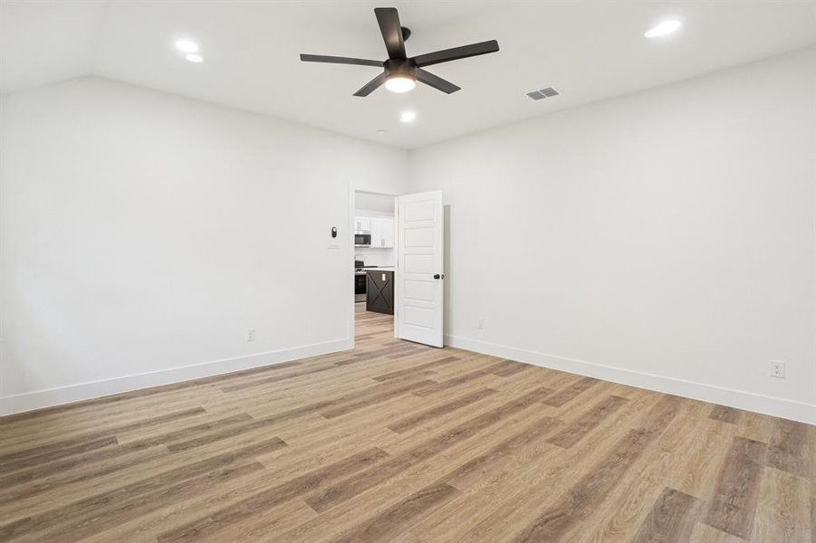 Empty room with light wood finished floors, recessed lighting, and ceiling fan Empty room with light wood finished floors, recessed lighting, and ceiling fan