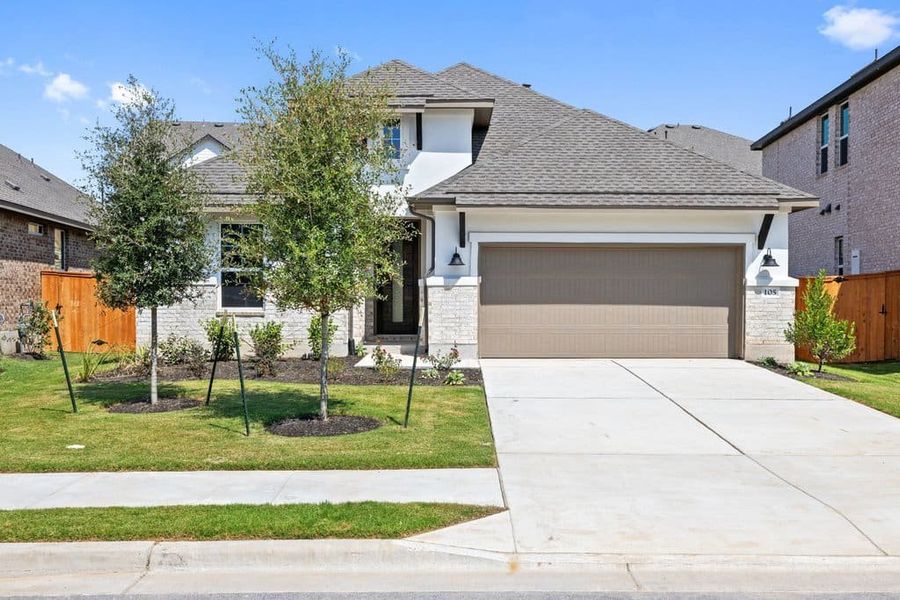 Front exterior of a new home in Lariat, Liberty Hill, TX, highlighting curb appeal (Image 2). Front exterior of a new home in Lariat, Liberty Hill, TX, highlighting curb appeal (Image 2).