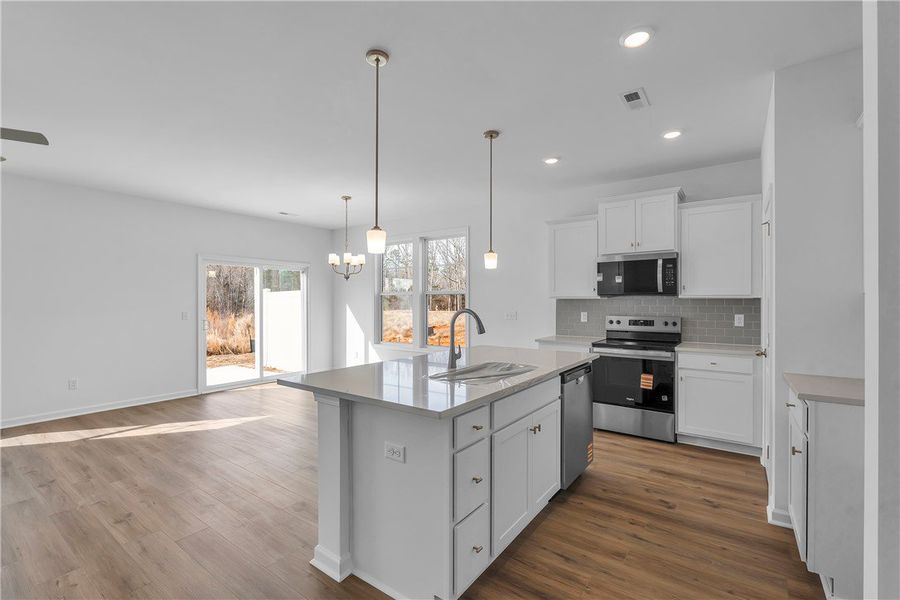 This spacious kitchen and living area features a m