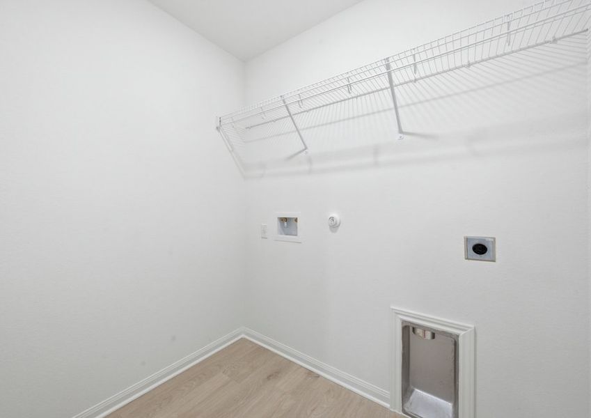 Laundry room featuring washer and dryer connections and a built-in shelf. Laundry room featuring washer and dryer connections and a built-in shelf.