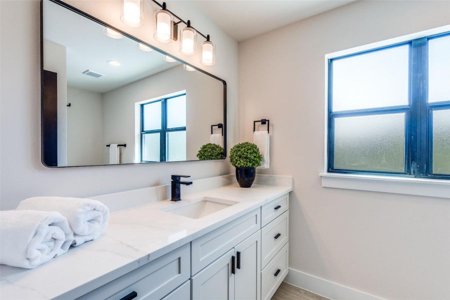 Bathroom featuring vanity and baseboards
